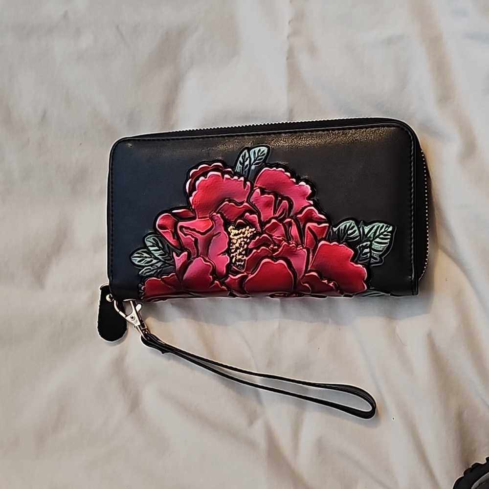 Beautiful wristlet, black with red and green hibiscus flowers embossed on it.
